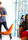 Colleagues In A Work Lounge Area With Orange Chairs Riverwood
